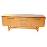 A Portwood Furniture vintage teak sideboard, with three central drawers flanked by a pair of cupboar