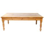 A pine kitchen table, the rectangular planked top on turned legs, 80cm high, 120cm x 213cm.