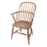 A 19thC ash and elm Windsor chair, the shaped back and arms with spindle turned supports, with solid