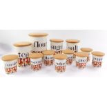 A set of Crown Devon Fieldings pottery kitchen storage jars, with turned beech covers. (11)