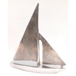 An Art Deco style aluminium model of a yacht, 37cm high, 30.5cm wide.