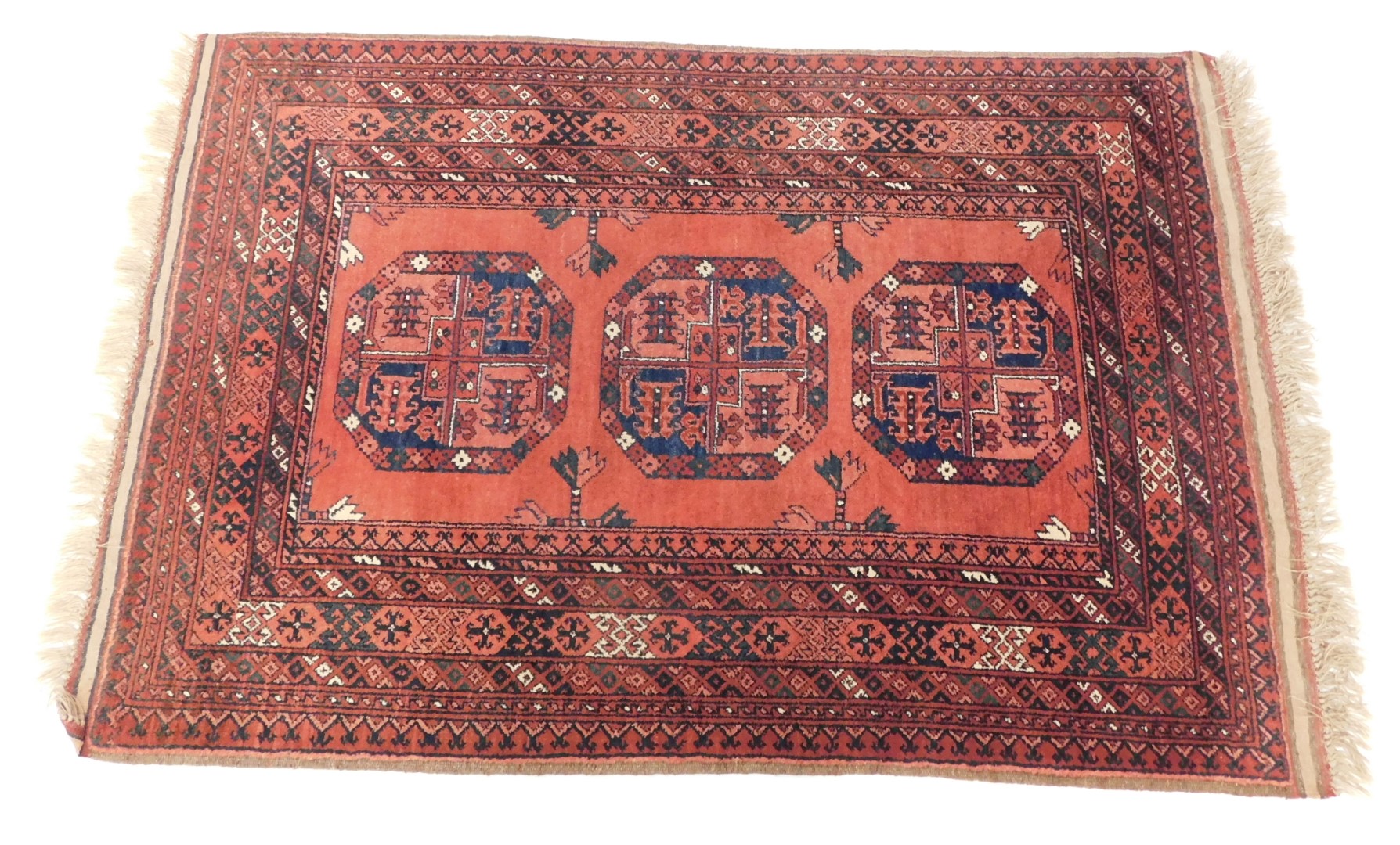 A Tekke rug, red ground decorated with three central guls, in repeating geometric borders, 153cm x 1