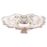 A Victorian silver centrepiece bowl, having elaborate scrolled and floriate rim, surrounding a multi