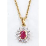 A diamond and ruby oval cluster pendant, on a yellow metal neck chain, stamped 585, 3.3g.