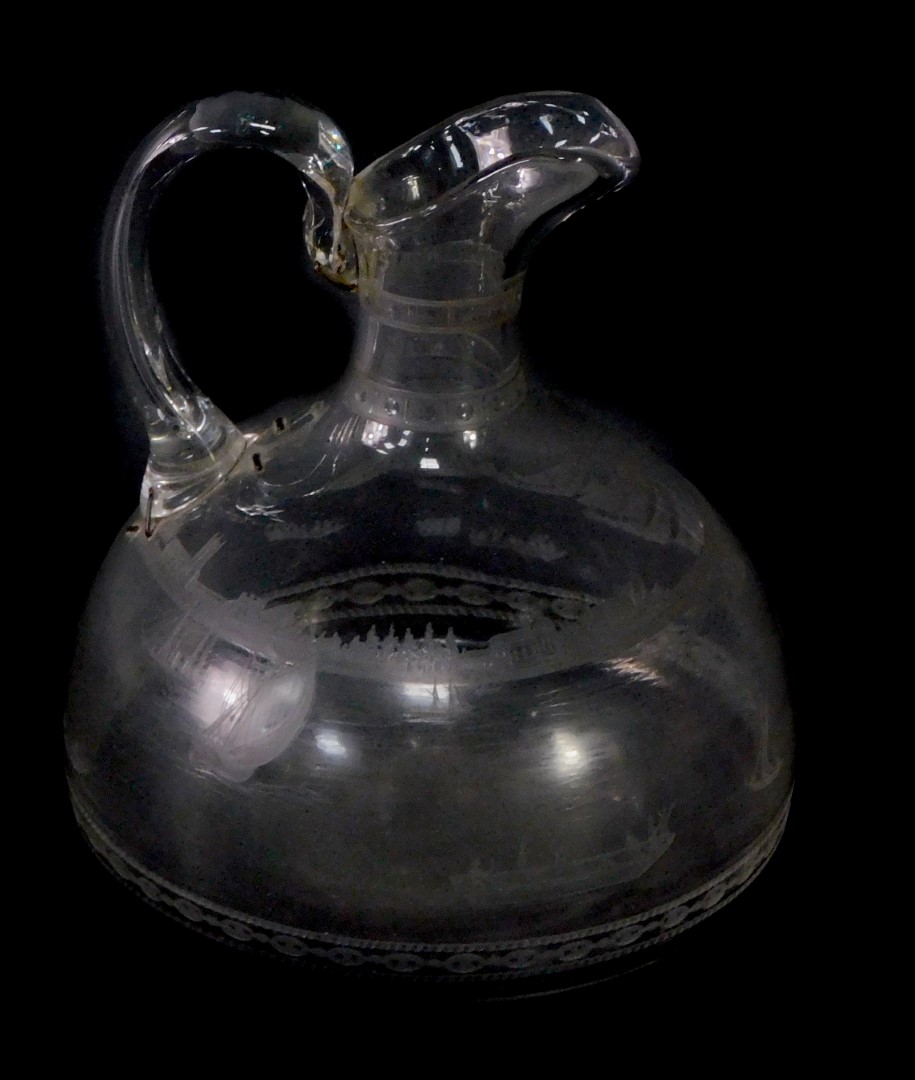 A 19thC engraved glass jug, possibly James Powell, Whitefriars, the body engraved with a sailing reg