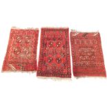 Three Caucasian prayer rugs, red ground, 109cm x 63cm, 94cm x 64cm, and 96cm x 64cm respectively.
