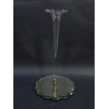 An early 20thC clear glass single trumpet epergne, raised on a shaped mirrored base, 49.5cm high.