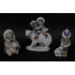 Three Lladro porcelain figures of Eskimo children with Polar bears, the tallest 18cm high.