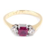 An 18ct gold ruby and diamond three stone ring, the diamonds approximately 0.25ct, size L, 2.7g.