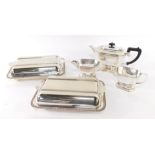 An electro plate three piece tea set, of canted form, and a pair of Art Deco silver plated entree di