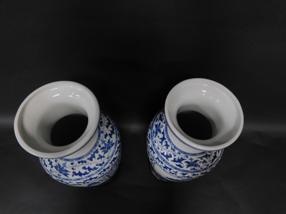 A pair of Chinese porcelain baluster vases, having blue and white landscape decoration, 54cm high wi - Image 3 of 3