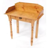 A pine washstand, with a raised back, frieze drawer, on turned tapering legs, 81.5cm wide.