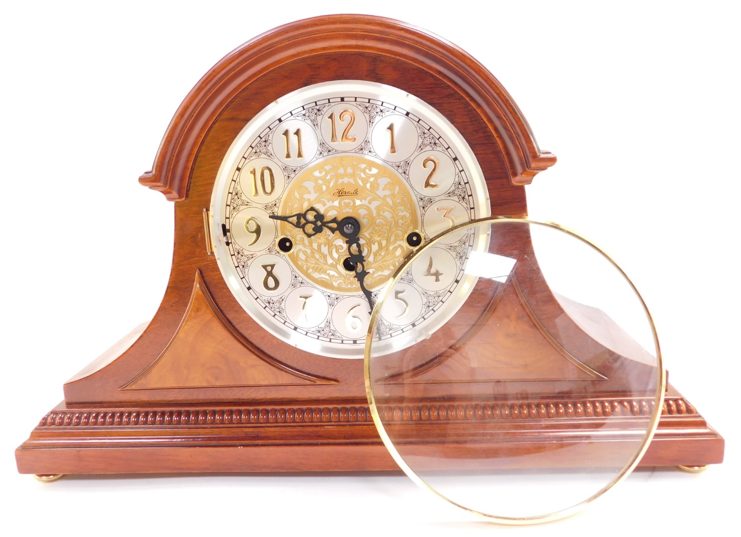 A Franz Hermle mahogany cased mantel clock, circular silvered dial bearing Arabic numerals with cent