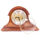 A Franz Hermle mahogany cased mantel clock, circular silvered dial bearing Arabic numerals with cent
