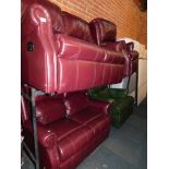 A red leather finish three piece suite, comprising two reclining sofas and a armchair in red, togeth