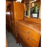 A 1930s oak bedroom suite, comprising wardrobe, dressing table chest and a further three drawer oak