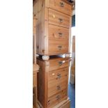 A pair of pine bedside chests of three drawers.