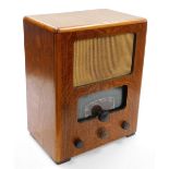 An oak cased radio, with two span dial, and various turning handles, 44cm high, 36cm wide, 22cm deep