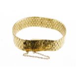 A 9ct gold bracelet, of articulated link form with bark effect finish, and safety chain, 43.9g.