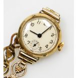 A 9ct gold cased ladies wristwatch, with small circular watch head on a gold plated floral design st