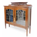 An Art Nouveau mahogany display cabinet, with molded cornice top and fret work detailing, above two