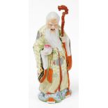 20thC Chinese figure of a bearded sage, standing holding staff, in flowing robes, in yellow, green a