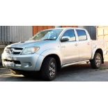 A Toyota Hilux Invincible 3.0D-4D pick up truck, registration LS07MXV, in silver with spare wheel, a