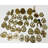 A collection of horse brasses, and brass carriage wheel hubs to include Joseph Atkinson of Leeds, Ki