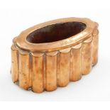 A Victorian copper jelly mould, of oval design with turreted borders stamped PF to upper rim, 9cm hi