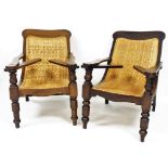 A pair of mid 20thC plantation chairs, each with hardwood frame on wicker rush seat, with tapered co