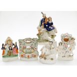 A group of five reproduction Staffordshire style flat back figures, to include male and female clock