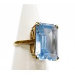 A dress ring, set with large rectangular aquamarine stone, in four two point claw setting, on a rais