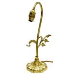 An Art Nouveau style brass table lamp, with curved top with leaf scroll branch decoration, converted