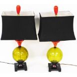 A pair of table lamps, in green glass on platform bases with blue shades surmounted by red bulbs, 81