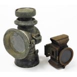 A railway inspection lamp, black metal, 22cm high, and a smaller brass example possibly for a bicycl
