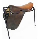 A leather riding saddle and stand.