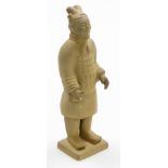 A Chinese Tang style figure of a standing warrior in flowing robes, on shaped base, 24cm high. (AF)