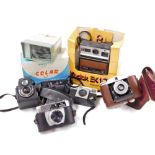 A group of camera equipment, to include a Kodak instant camera, a ful-vue box camera, a Pentax flash