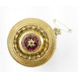 A Victorian memorial brooch, with central six triangular cut rubies, and a diamond with twist design