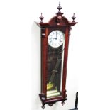 A Kieninger mahogany cased drop dial wall clock, with weights and pendulum, 120cm high, 38cm wide.