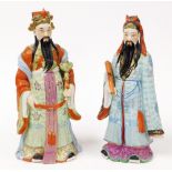 A matched pair of 20thC figures of standing bearded sages, each in flowing robes, the first in green