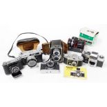 A group of cameras, to include an Olympus Trip 35, conversion lens set, Canon QL, Exata camera, etc.