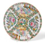 An early 20thC Cantonese Famille Rose plate, centred by flowers with outer flowers of further flower