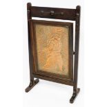 An early 20thC oak framed brass fire screen, the copper panel Brunhild Siegfried from German legend,