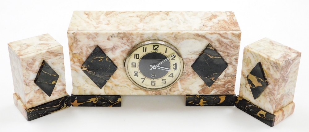 An Art Deco marble clock garniture, in pink and cream finish with applied black diamond detailing, w