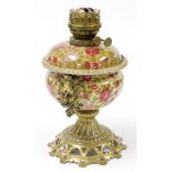 A Fisher & Budapest oil lamp, on ceramic body with floral decoration and pierced and flowered stem a