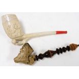 Two pipes, a decorative pipe with bearded figure head and turned wooden handle, 21cm wide, and a pre