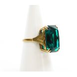 A dress ring, set with large rectangular green paste stone, in four double claw setting, on a raised