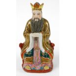 A 20thC Chinese figure of a bearded sage, in seated pose, in flowing robes in yellow, pink and blue,