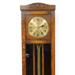 An oak cased longcase clock, with brass clock face, with floral banded arched top and mirrored centr